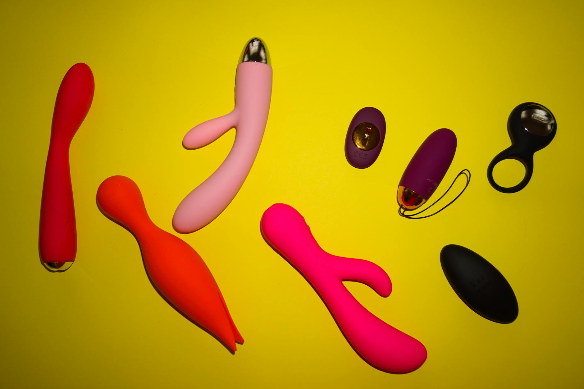 Woman holding silicone vibrators, exploring sensation and pleasure recovery