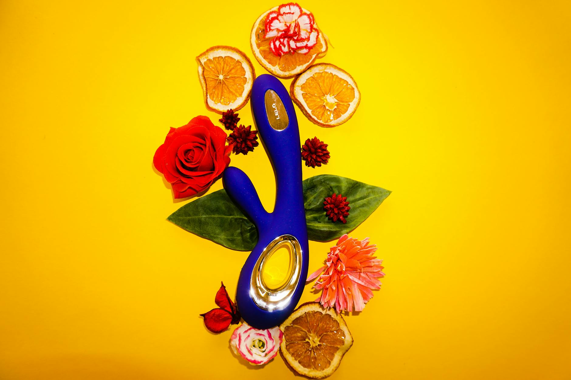 Close-up of hands holding a sleek blue vibrator, representing the gentle reconnection to pleasure after illness recovery.