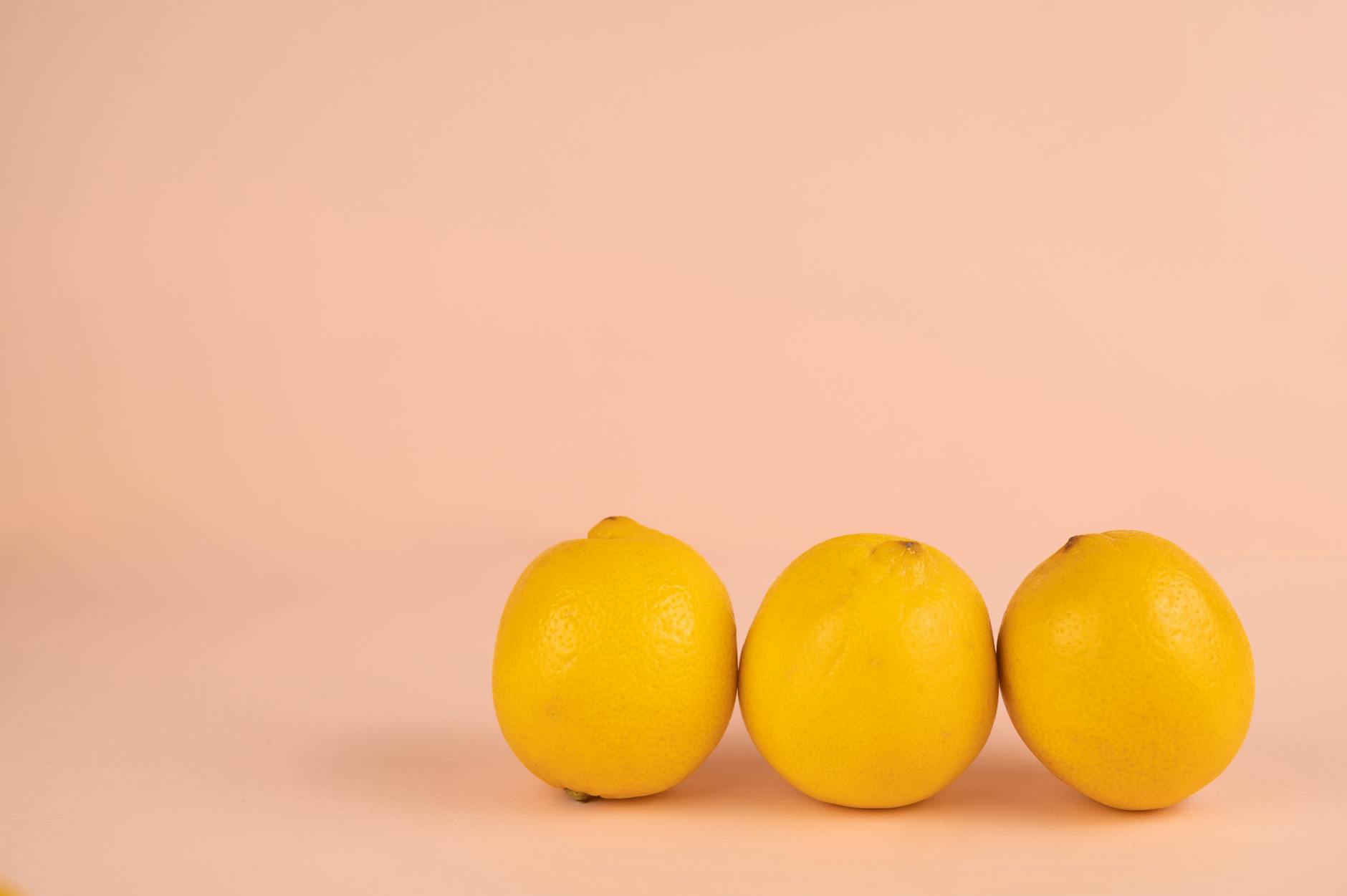 Bright ripe lemons on a pastel background, symbolizing fresh starts and natural pleasure